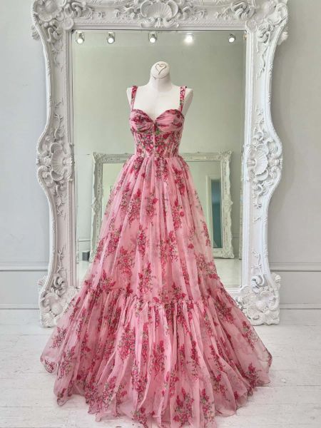 Front view of a pink floral print A-line prom dress with delicate spaghetti straps.