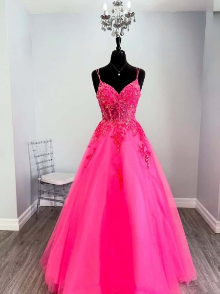Front view of a hot pink tulle prom dress with sparkling sequin applique details.