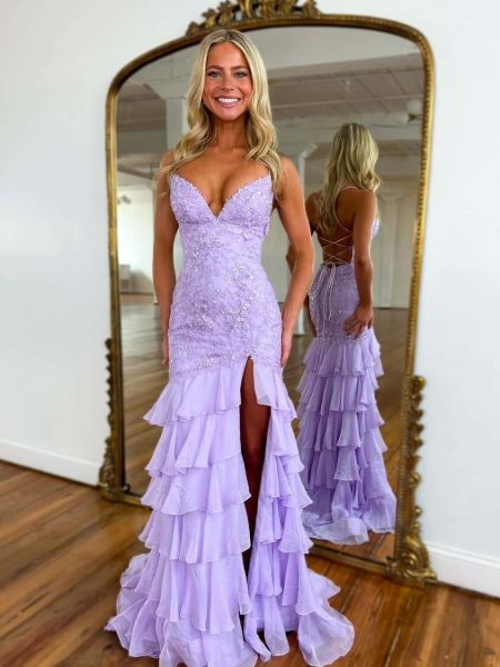 Front view of a romantic lavender prom dress with lace applique, a mermaid silhouette, and ruffled hem.