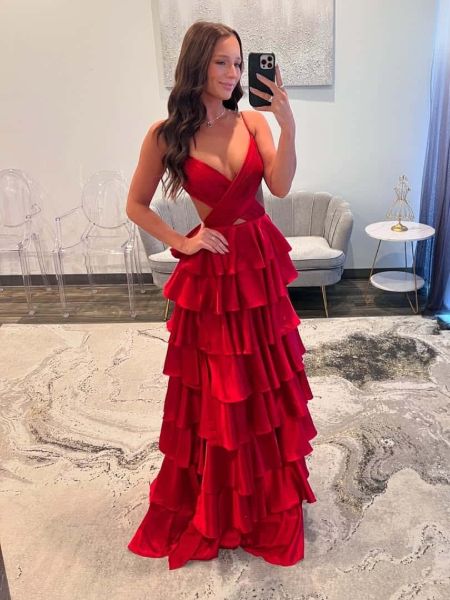 Front view of a bold red satin prom gown with thin spaghetti straps and a sexy cutout waist.