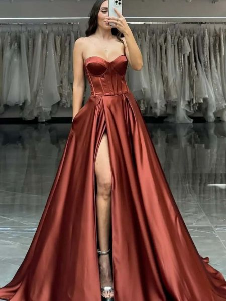 Front view of a unique rust brown satin prom dress with a sweetheart neckline and corset bodice.