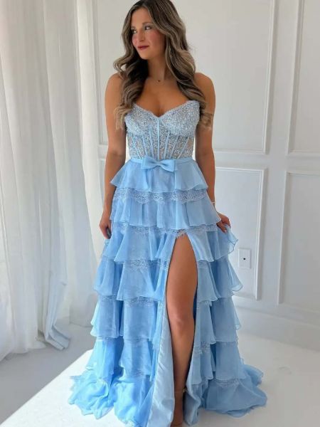 Front view of a light blue prom dress combining a lace corset bodice with a tiered ruffled skirt.