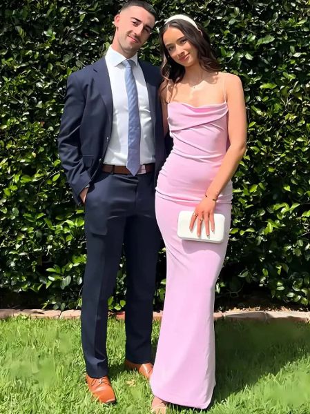 Front view of a light pink strapless prom dress featuring a draped cowl neck and a mermaid silhouette.