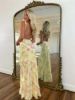 Back view of the yellow maxi dress, showing ruffles and print continuing to a V-back or tie detail.