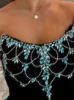 Close-up of the intricate black and blue beadwork forming patterns or ombre effects.