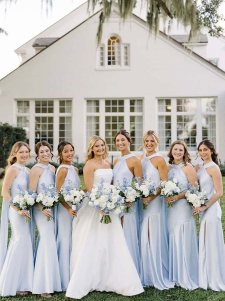 Front view of a light blue satin bridesmaid dress with a halter neckline and a high side slit.