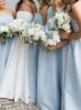 Group of bridesmaids in matching light blue strapless dresses, creating a cohesive look.