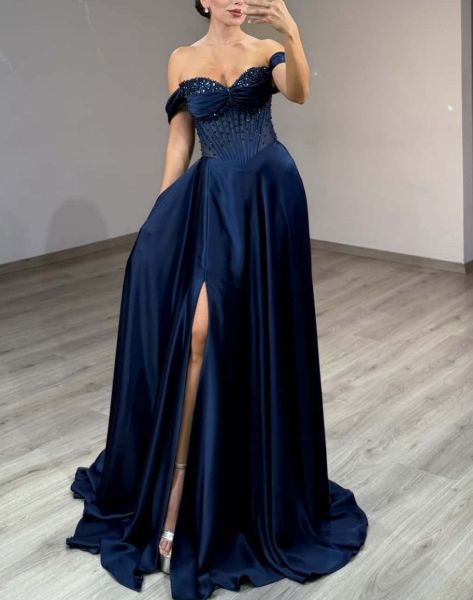 Navy blue evening gown with a trendy corset-style bodice and flowing skirt.