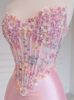 The blush pink floral corset prom dress, looking elegant and romantic.