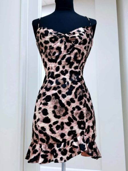 Sparkly leopard print homecoming dress with thin spaghetti straps and a sequined bodice.