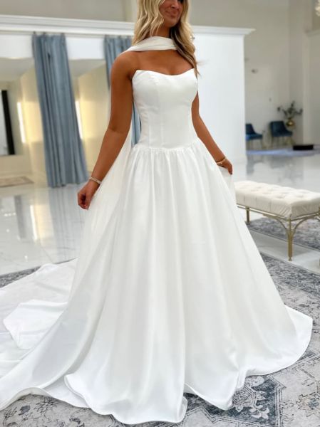 White strapless satin wedding dress worn with a matching detachable tulle or lace shawl.