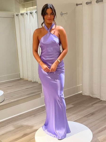 Lavender satin bridesmaid dress with a halter neckline and a fitted mermaid silhouette.