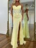Strapless mermaid yellow prom dress with intricate applique detailing on the bodice and skirt.