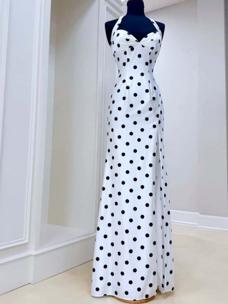 Black and white polka dot prom dress with a halter neckline and satin fabric.
