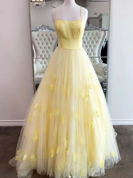 Bright yellow prom dress with thin spaghetti straps and 3D floral appliqué on the bodice.