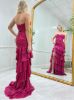Back view of the hot pink ruffled dress, showing the strapless back and flowing ruffles.