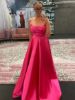 Model wearing the magenta ball gown, looking elegant and regal.