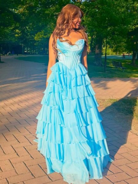 Strapless sky blue evening gown with multiple tiers of soft, chiffon.