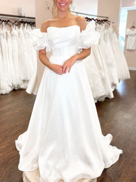 Modern strapless satin wedding gown with dramatic puffy sleeves and sweetheart neckline.
