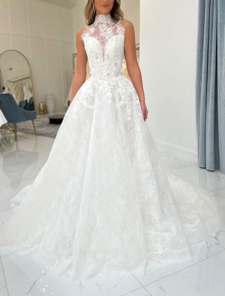 A-line wedding dress with romantic high neckline and intricate all-over lace.