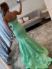 Back view of the mint green mermaid dress, showing the bow placement and mermaid flare.