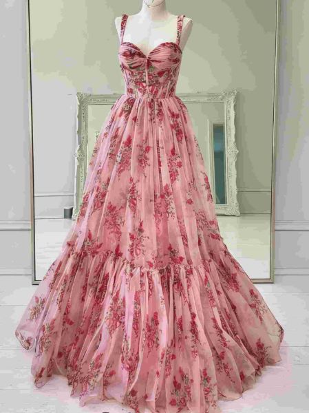 Front view of a pink floral print A-line prom dress with delicate spaghetti straps.