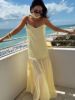 Pale yellow spaghetti strap maxi dress alone, showcasing the simple, elegant silhouette.