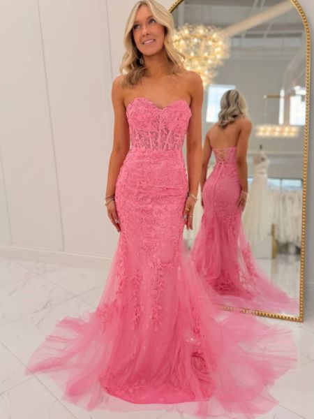 Hot pink sweetheart mermaid prom dress with intricate applique details on bodice and skirt.