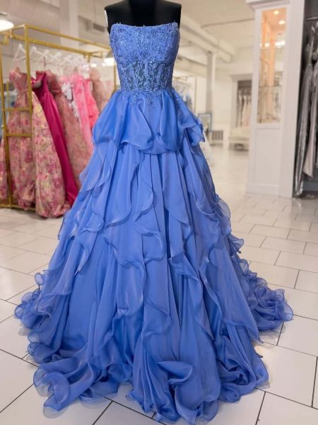 Periwinkle blue strapless prom gown with applique details and full, layered skirt.