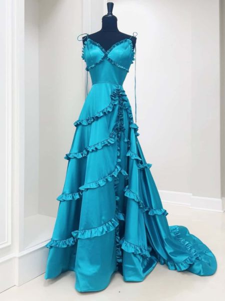 Teal V-neck A-line prom dress with cascading ruffles on bodice and dress.