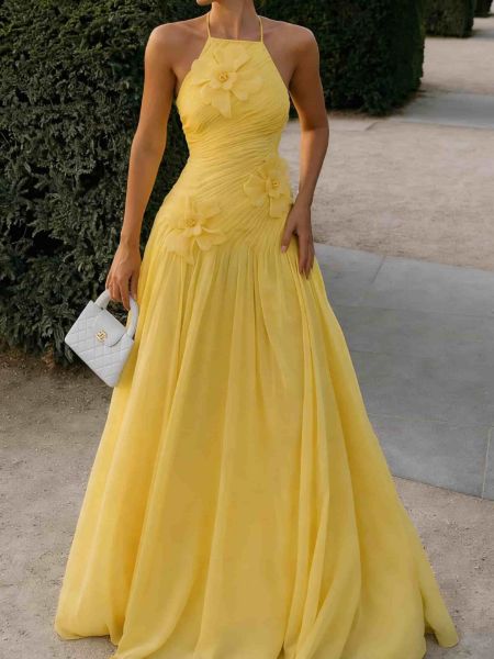 Fit pleated halter yellow prom dress with dramatic 3D floral appliqué and fitted silhouette.
