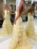 Back view of yellow cutout ruffled dress, showing mermaid flare and continuing ruffle details.