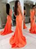 Back view of orange halter mermaid dress showing elegant open back, halter ties, and dramatic train.