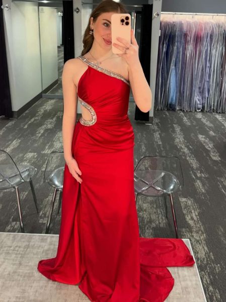 Red satin one shoulder rhinestone dress with strategic side cutout and elegant floor-length silhouette.