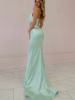 Back view of mint green satin mermaid dress showing fitted silhouette, dramatic flare, and elegant train.